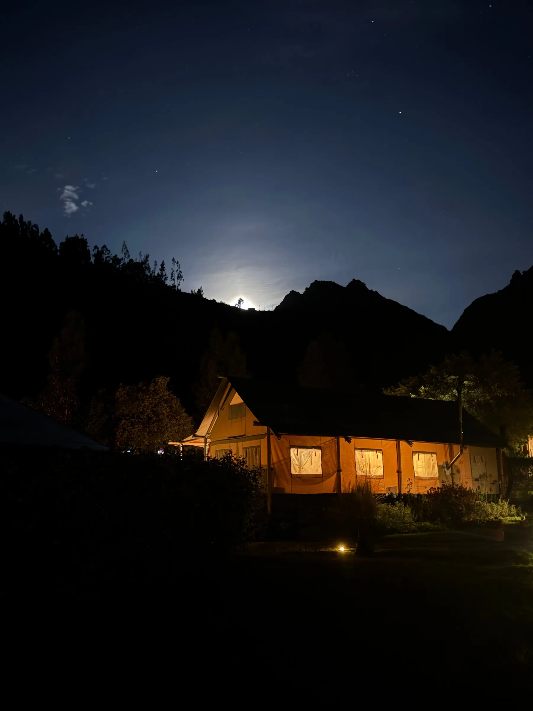 The lodge after dark, under a bright moon