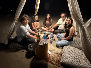 The long table under the canopy, after dark